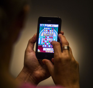 LOS ANGELES, CA - MAY 16, 2013 - A person playing the Candy Crush Saga game, as beeing photographed in the Los Angeles Times studio, May 16, 2013. (Ricardo DeAratanha/Los Angeles Times)